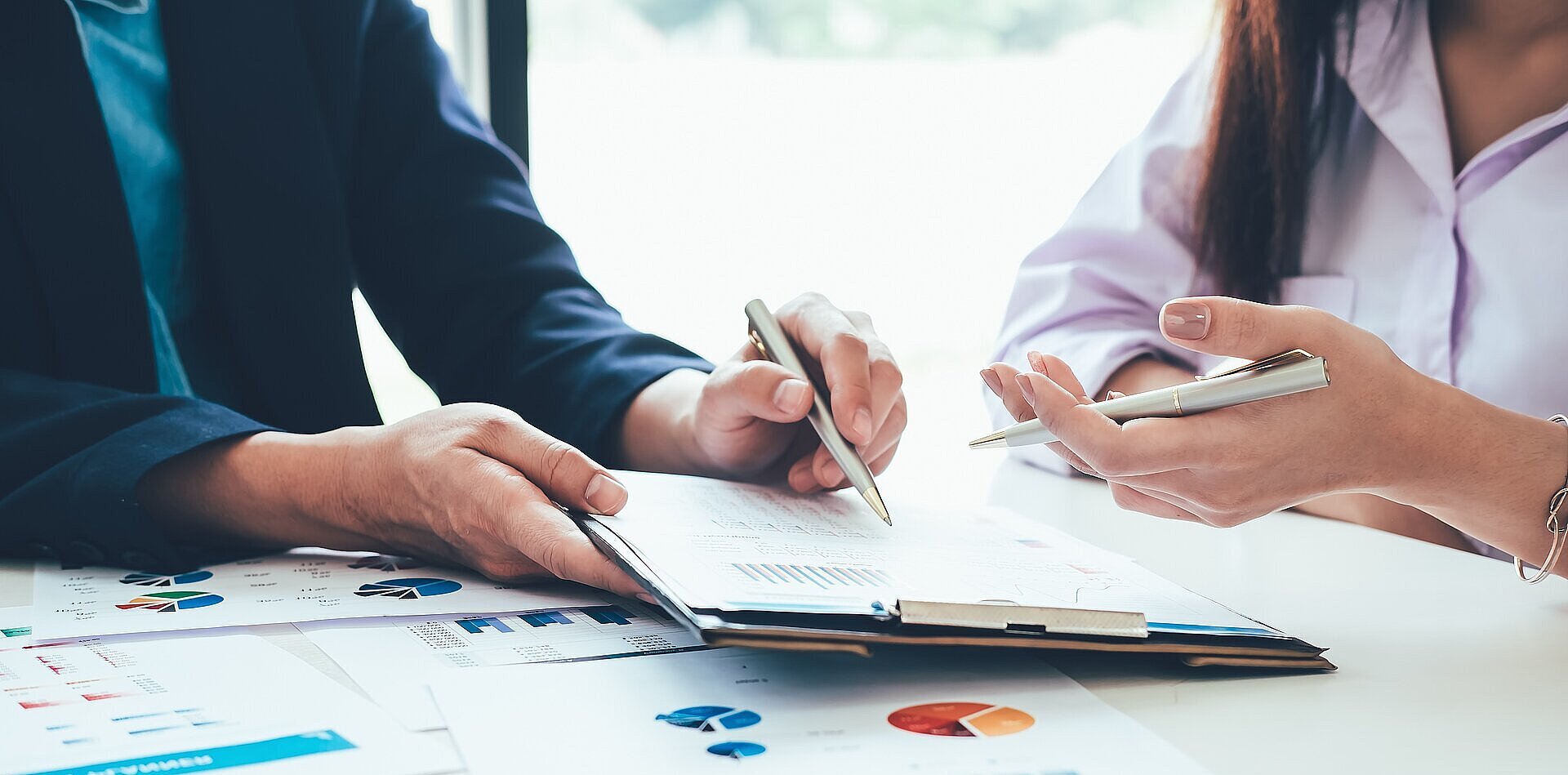 Business people sitting at a desk with documents on it