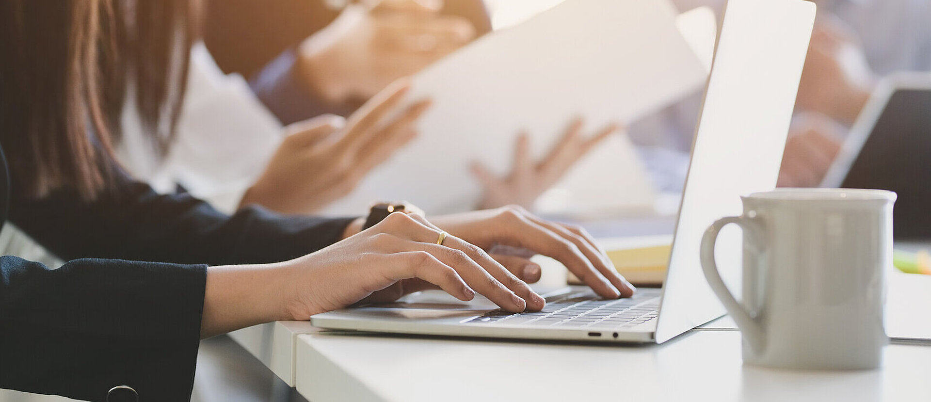 Close up view of business people typing on computer laptop 