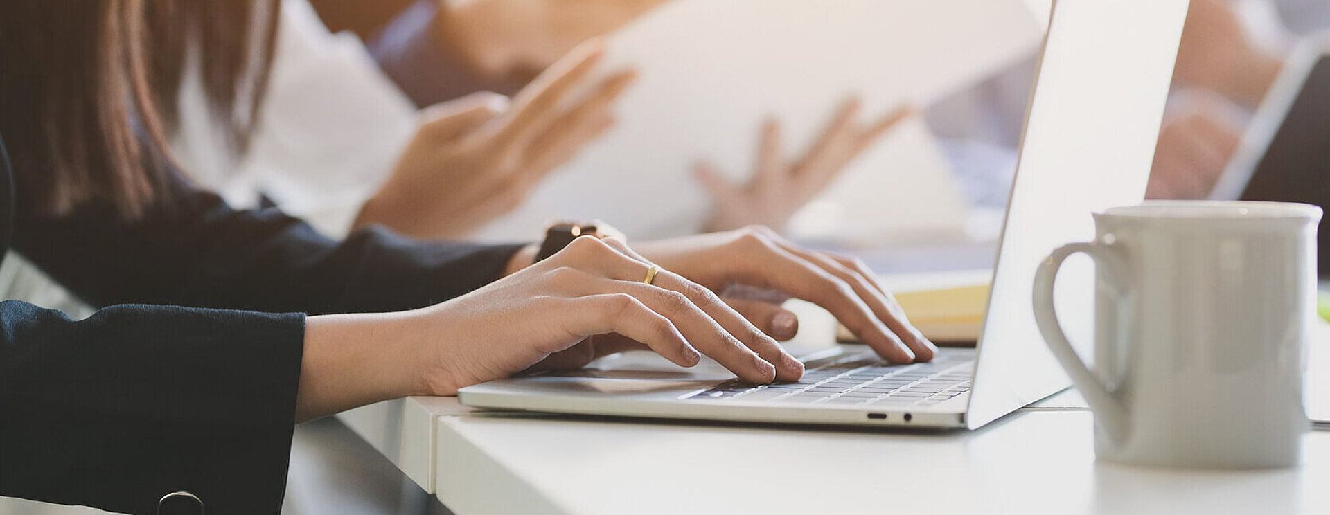 Close up view of business people typing on computer laptop 